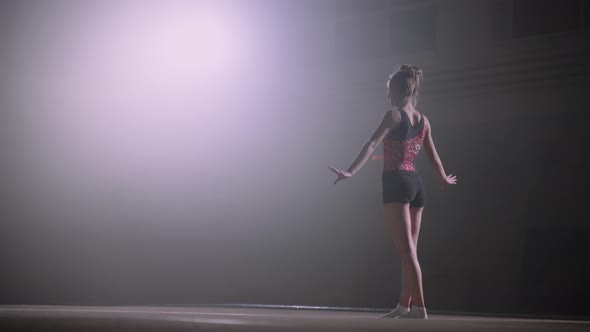Junior Female Gymnast is Standing on Floor Preparing to Start Exercising Training or Competition alt