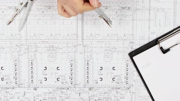 Engineers Are Sitting at the Table Analyzing the Drawing. Close Up alt