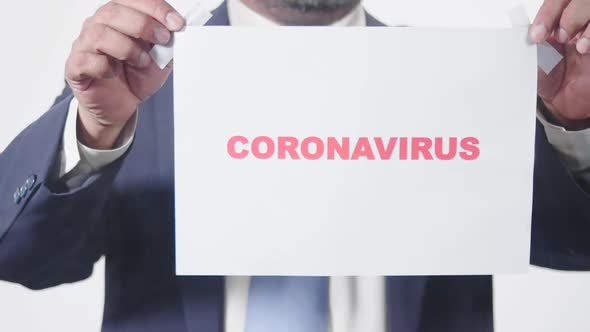 Business Man Posts Sign On Glass Window Coronavirus