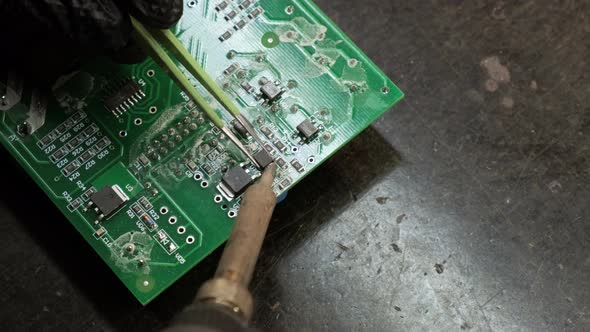 Close-up of soldering a circuit board. Slow motion. alt