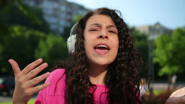 Wearing Pink Tshirt Listening Music with Headset and Enjoying Walking Outside alt