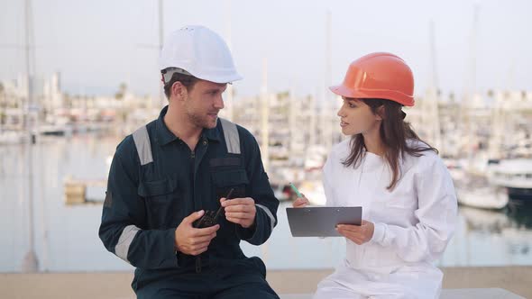 Yacht Club Worker Talking with New Employee alt