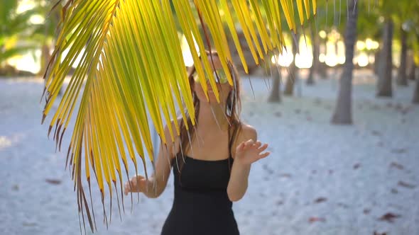 A Young Woman Relaxes in a Tropical Resort with Hot Springs, Waterfalls and Swimming Pools with Hot alt