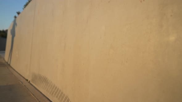 Silhouette Shadow of Slim Female Dancer Spinning in Sunlight Reflecting on Wall alt