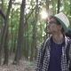 A Tourist Walks Through a Dense Green Forest - VideoHive Item for Sale
