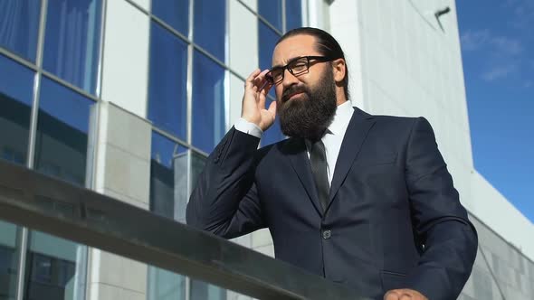 Tired Businessman Rubbing Temples and Taking Off Glasses Outdoors, Headache