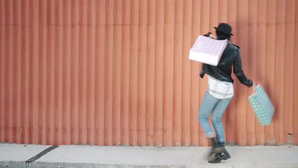 Portrait of Joyful Girl Satisfied Customer Walking with Shopping Bags Dancing Smiling with Wall in alt