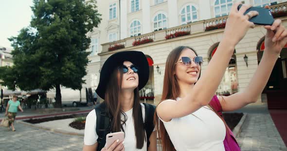 Two Tourist Girls Taking Photo on Phone