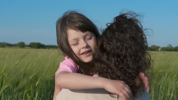 Happy child hugging mom. alt
