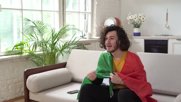 Italian Fan with Flag is Watching Sports or Football at Home alt