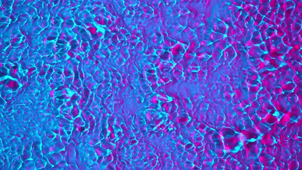 Super Slow Motion Abstract Shot of Swirling Neon Water at 1000Fps alt