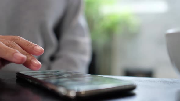 Closeup of a woman touching and scrolling on smart phone screen