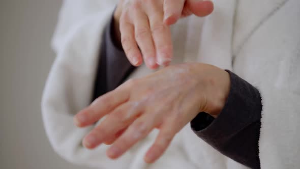 Closeup Mature Caucasian Female Hands Applying Moisturizer alt