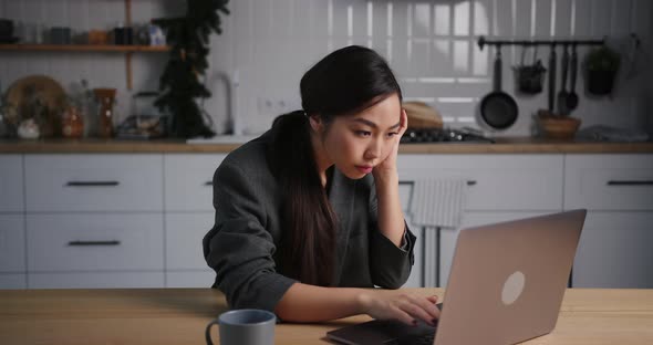 Asian Business Woman Use Laptop and Tired While Working From Home in the Evening on Holidays alt