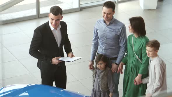 Mother Father and Child Buying Car at Dealership a New Family Auto alt