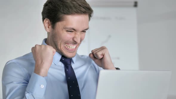 Close Up of Excited Businessman Celebrating Successful Project alt