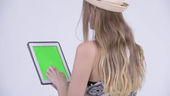 Closeup Rear View of Blonde Tourist Woman Using Digital Tablet alt