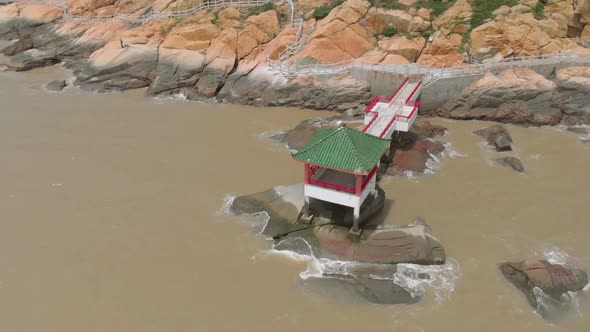 Aerial orbit shot of traditional Chinese pavilion on the coast of Coloane, Macau alt