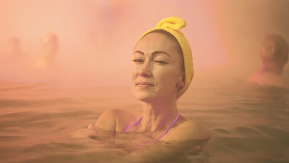 Close Up Caucasian Woman in a Swim in Hot Saline Mineral Water Bath at a Traditional Spa Outdoor alt