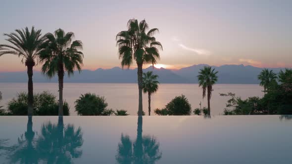  - Resort Scene with Swimming Pool, Sea and Mountains at Sunset alt
