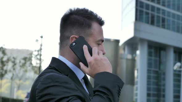 Businessman Talking on Phone Outside Office alt