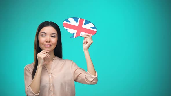 Curious Woman Holding British Flag Sign, Learning Language, Education Abroad alt