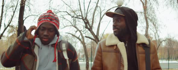African American Men Walking and Chatting in Park alt