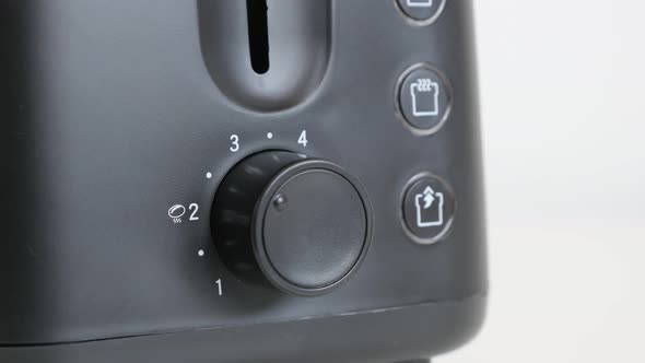 Lowering temperature and leveler on black toaster 4K video