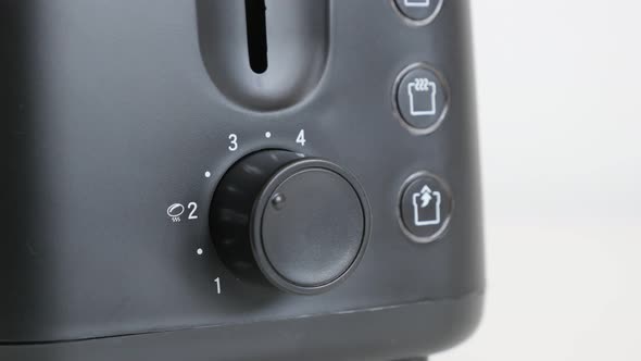 Lowering temperature and leveler on black toaster 4K video alt