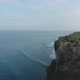 Aerial orbit shot around a Temple located near high rough cliffs and surrounded with ocean in Bali - VideoHive Item for Sale