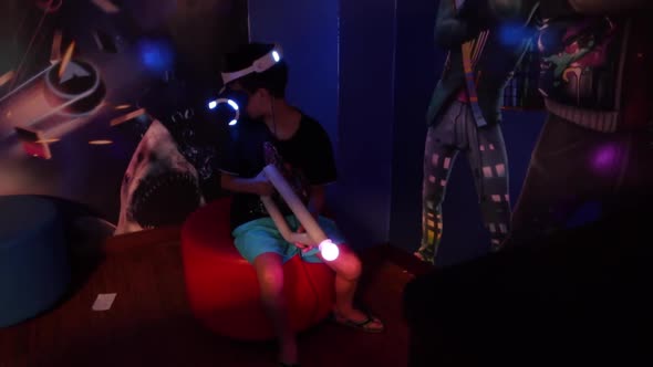 Boy in VR Glasses of Virtual Reality Playing Game