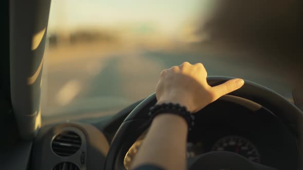 Woman Hand on a Steering Wheel No Blurred Background Road