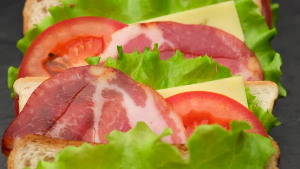 sandwich. large sandwich for Breakfast or lunch close up. making of the fastfood at home alt