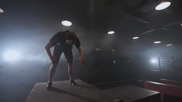 Free Running Young Man Doing a Series of Somersaults on the Training Ground for Parkour and Workout alt