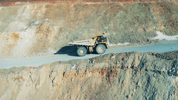 Truck Loaded with Ore is Riding Through the Mine Deposit alt