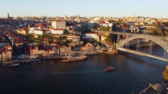 Drone Footage of People Walking Along the Porto Embankments at Sunset