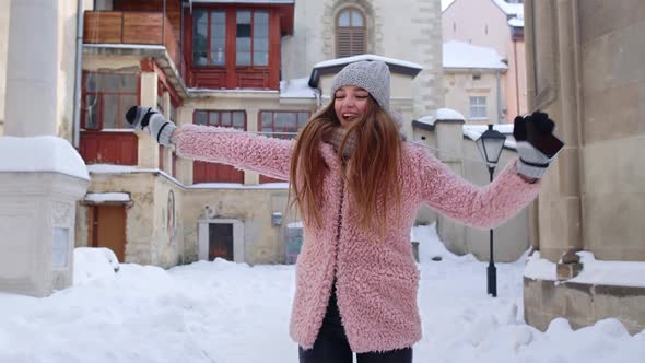 Woman Traveller in Winter City Reading Online Sms Mobile Phone Winning Prize Dancing Celebrating alt