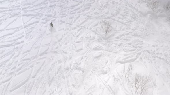 Skier Riding on Mountain Ski From Snowy Slop at Winter Resort. Aerial View  alt