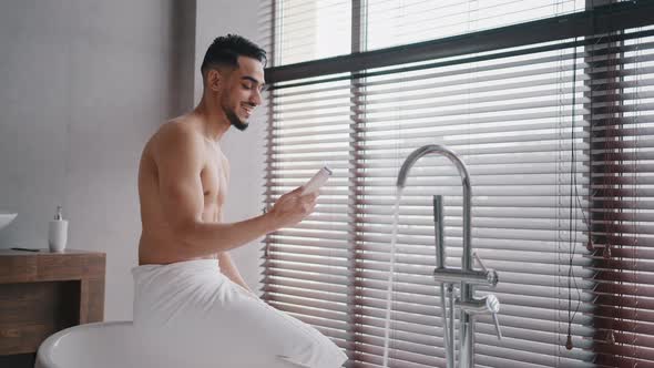Morning Bath Arab Indian Spaniard Naked Sexy Bearded Man with Bath Towel on Hips Sits in Bathroom alt