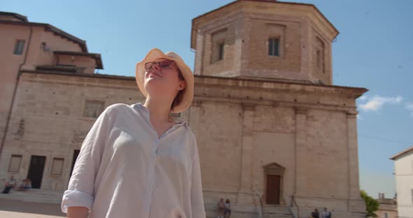 Traveler woman in hat sightseeing antique cathedral in Italy