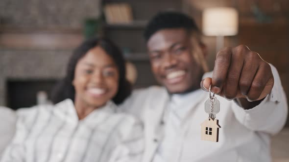 Blurred Unfocused View African American Married Couple Newlyweds Wife and Husband Holding Keys to alt
