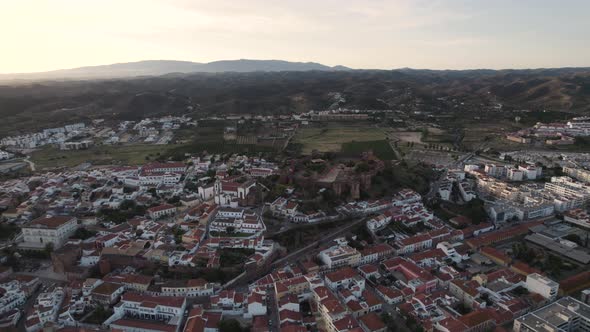 Rotating aerial showing the castle and old town in Silves, Portugal alt