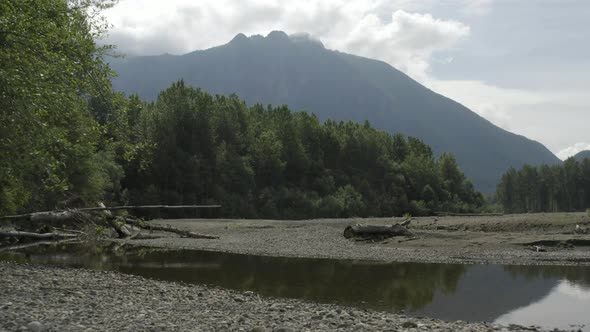 Flying Above Dried Up Snoqualmie River Majestic Gimbal Shot   Looming Mountain Background alt