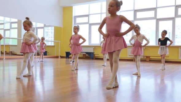 Group of little girls practicing in ballet school