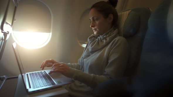 Girl Using Laptop While Is Sitting in Plane