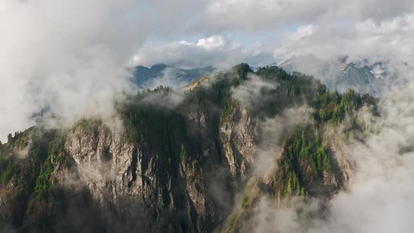 Aerial Clouds Over Lush Rainforest Mountain During Rainy Season in Northwest USA alt