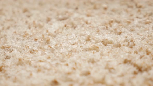 Fresh shallow DOF slow tilt over  bread ready for toasting close-up 4K 2160p 30fps UltraHD footage - alt