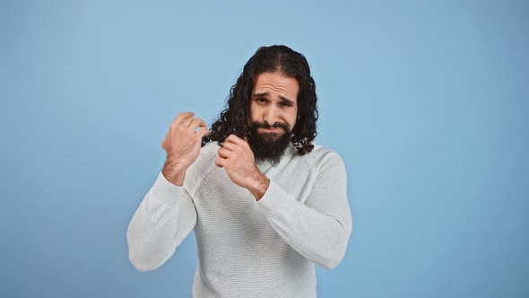 Disappointed Bearded Guy with Long Hair Checking His Hair Condition Looking Displeased with His alt