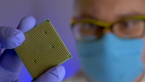 Engineer's Hand Holds Sample of Processor at Technology Plant