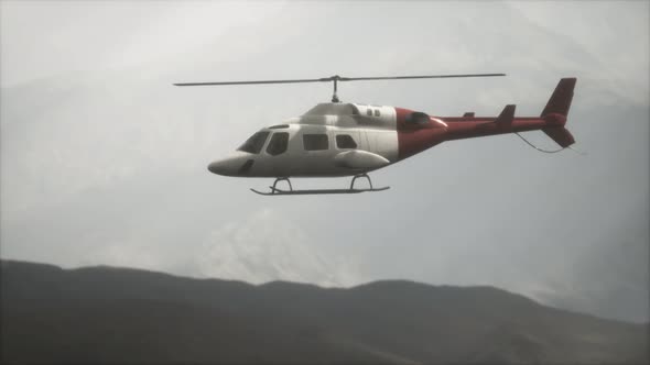 Extreme Slow Motion Flying Helicopter Near Mountains with Fog alt
